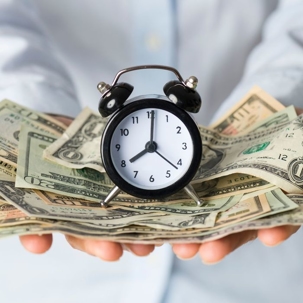 time and money in hands