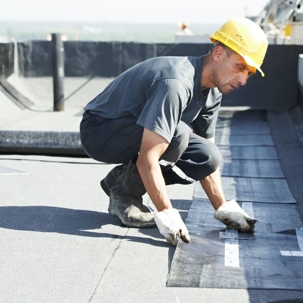 man fixing a flat roof