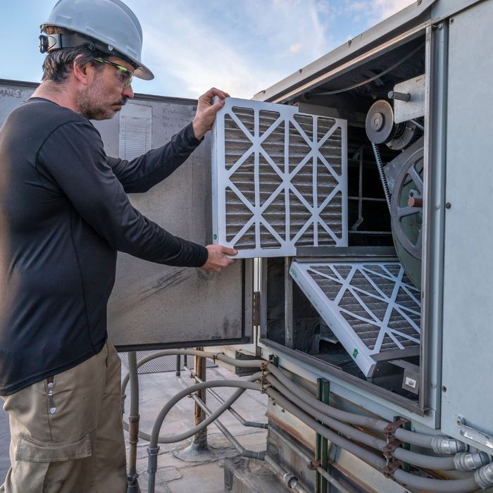 Worker working on an HVAC system for a commercial building